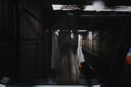 horror woman with white cloth standing in elevator tunnelの写真素材