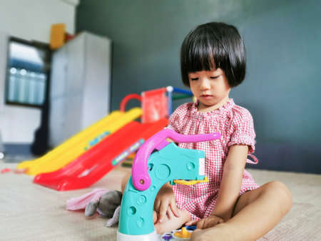 Sweet Asian Little girl playing toy indoor at homeの写真素材