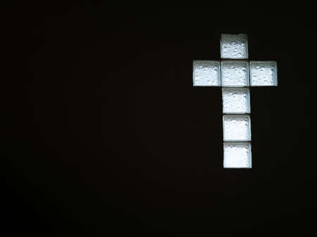 White glass block wall in shape of cross inside building viewの写真素材
