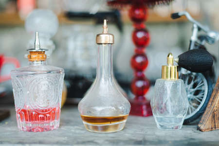 Glass bottles, vintage cut glass decanters and crystal carafes with different alcoholic drinks and liquorsの写真素材