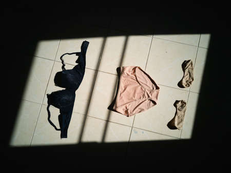 women's underwear, panties bra and sock dry on floor, Slum life poverty conceptの写真素材