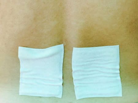 Medicated pain relief patch, plaster. man with back pain. Pain relief and health care conceptの写真素材