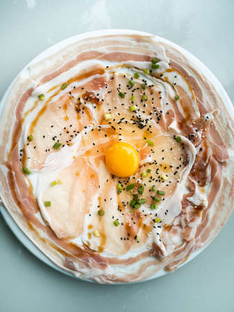 raw sliced pork with sauce on dish for grill or hot potの写真素材