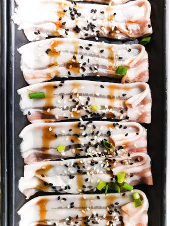 raw sliced pork with sauce on dish for grill or hot potの写真素材