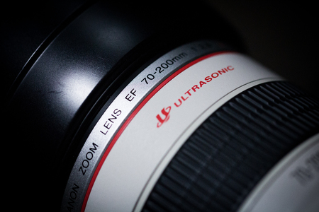 BANGKOK, THAILAND - January 18, 2017: DSLR Camera lens, Canon EF 70-200mm f/2.8L USM on a dark background. Low-key studio shot.のeditorial素材