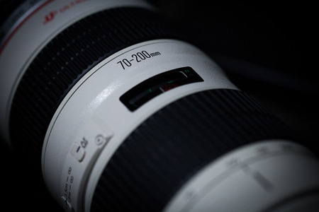 BANGKOK, THAILAND - January 18, 2017: DSLR Camera lens, Canon EF 70-200mm f/2.8L USM on a dark background. Low-key studio shot.のeditorial素材
