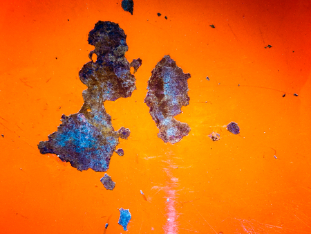 Rust on the orange metal sheet.の写真素材