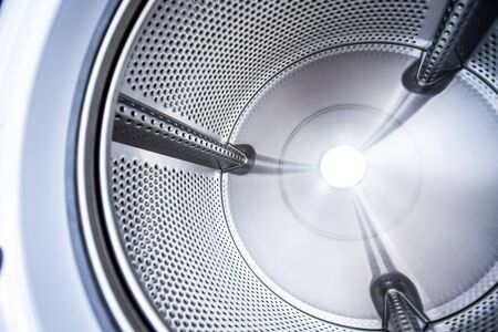 Close up photo of inside washing machine drum.の写真素材