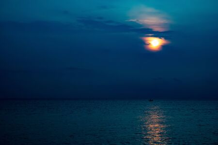 Beautiful sunset/sunrise at the sea with reflection in the water.の写真素材