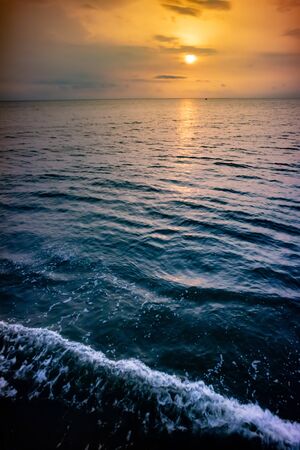 Beautiful sunset/sunrise at the sea with reflection in the water.の写真素材