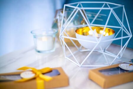 Electric candle in a cup and surrounding with wired cage. The wedding decoration.の写真素材