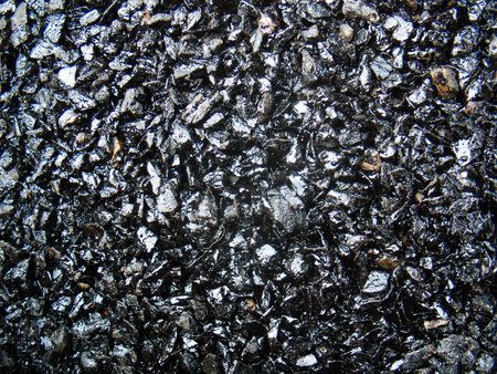 Asphalt to build a new road is not dry in the near view.の写真素材