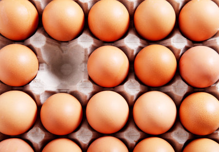 Close-up of a group of eggs in their package. An empty space