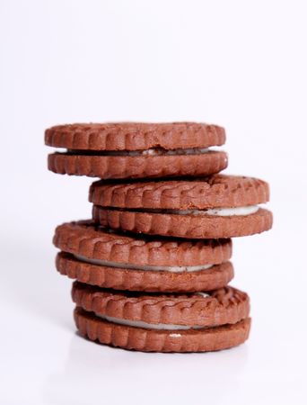 Four chocolate cookies on a white towerの写真素材