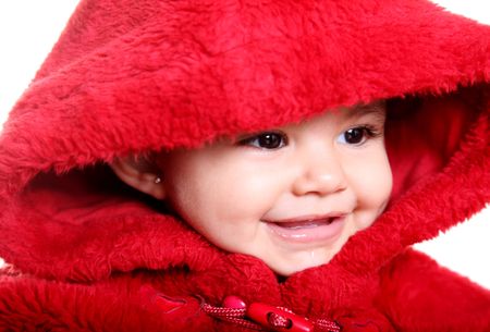 Beautiful baby with red hood over white backgroundの写真素材