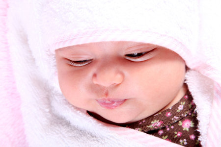 Beautiful baby on white blanket. Only face