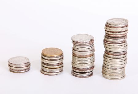 Four piles of coins on white background. Growth moneyの写真素材