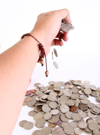 Hand with many falling coins. White Backgroundの写真素材