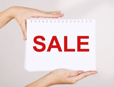 Woman hands showing sale advertisement ver white backgroundの写真素材