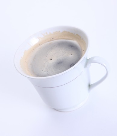 White cup with coffee over white background の写真素材