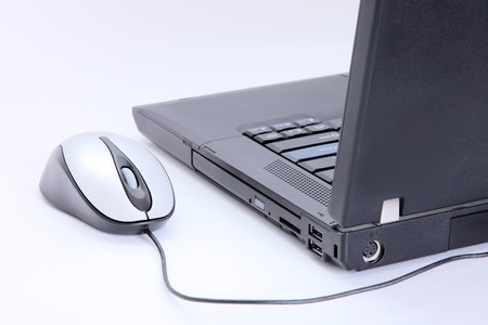 Laptop with mouse over white background. Technology image  の写真素材
