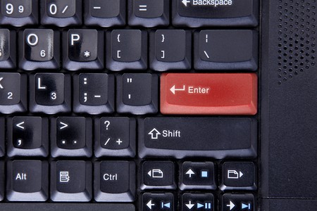 Computer keyboard with red colored enter keyの写真素材