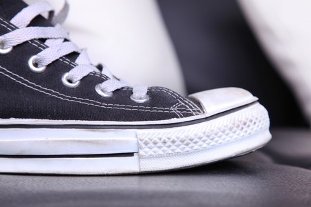 black and white gym shoes on a table の写真素材