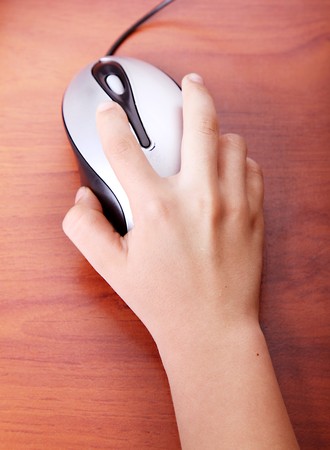 Child's hand over the computer mouse. tec hnology image. High viewの写真素材