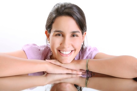 Face of a girl smiling and looking at the camera,  mirror reflectionの写真素材