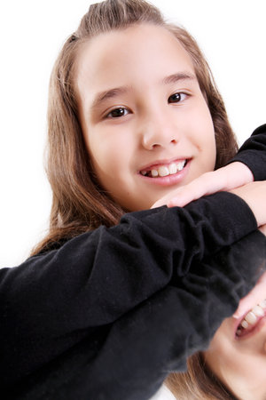 Girl smiling and looking at the camera over white backgroundの写真素材