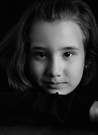 Ten years old girl looking at camera. Black and white close up. Portraitの写真素材