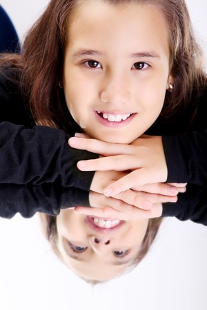 Girl smiling and looking at the camera. Reflection on mirrorの写真素材