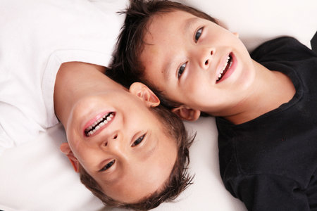 Two boys smiling and looking at the cameraの写真素材