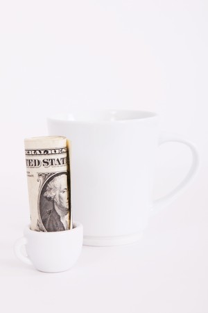 Big and small white cup, with one dolar, money conceptの写真素材