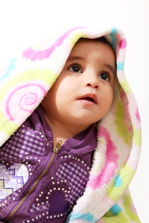 Face of a baby with a blanket over his headの写真素材