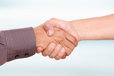 Men shaking hands, business image on blue backgroundの写真素材