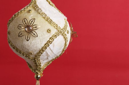 White and gold christmas ball on red background, space to add text or designの写真素材