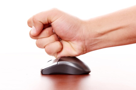hand hitting a computer mouse over white background. Concept stress の写真素材