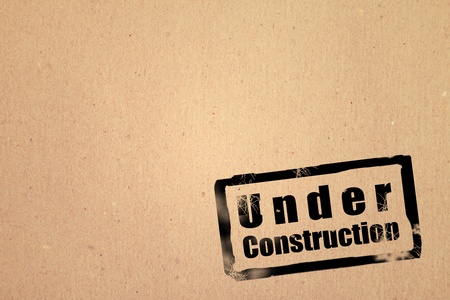 Wooden surface with stamp of under constructionの写真素材
