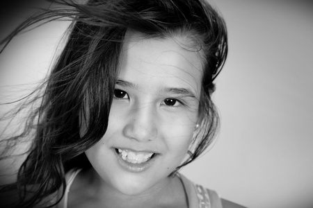 Photograph of a girl with her hair up in the wind in black and whiteの写真素材