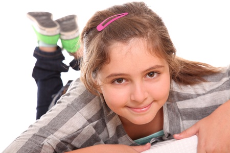 girl lying down isolated over white backgroundの写真素材