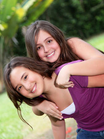 Two young girls playing on park and looking at the cameraの写真素材