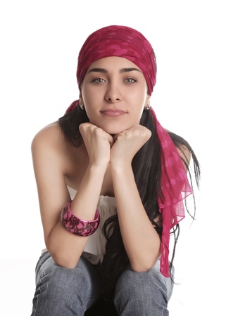 young woman sitting looking at the camera, white backgroundの写真素材