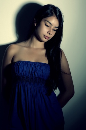 young woman with sad expression looking downの写真素材