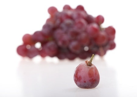 grape with a background of a bunch of grapes の写真素材