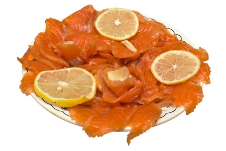 Red fish with lemon on a plate.の写真素材