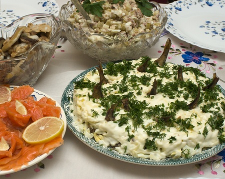 Dishes with a variety of salads and appetizers at the tableの写真素材