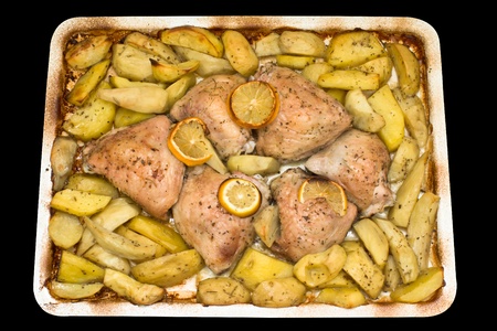 Roasted chicken thighs with potatoes and lemon.の写真素材