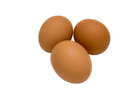 Three chicken eggs isolated on a white background.の写真素材
