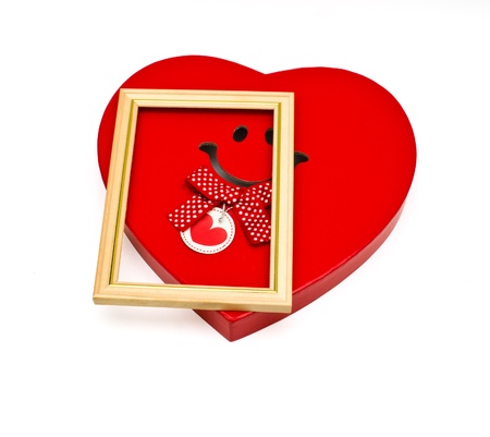 Box in the form of a heart and a frame for photosの写真素材